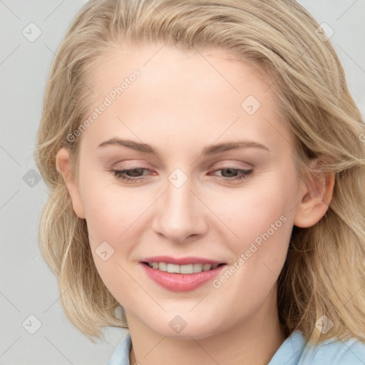 Joyful white young-adult female with medium  brown hair and blue eyes