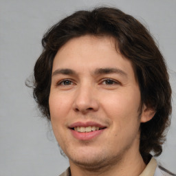 Joyful white young-adult male with medium  brown hair and brown eyes