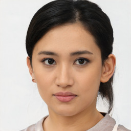 Joyful asian young-adult female with medium  black hair and brown eyes