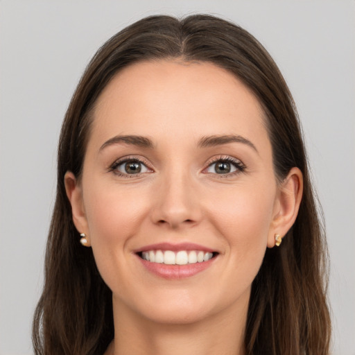 Joyful white young-adult female with long  brown hair and brown eyes