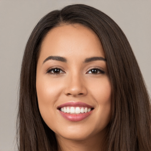 Joyful white young-adult female with long  brown hair and brown eyes