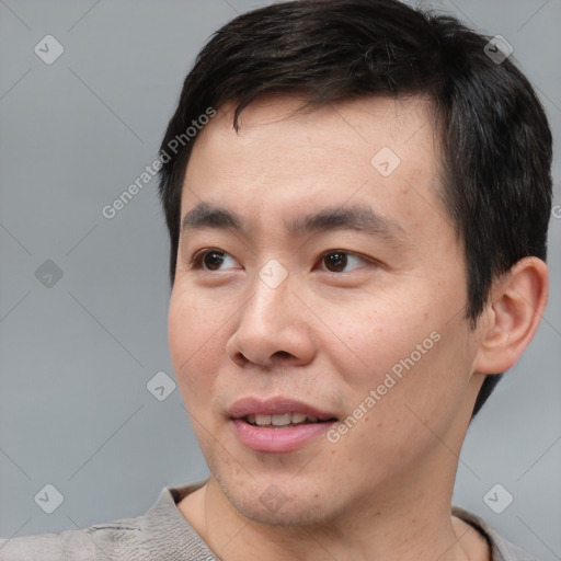 Joyful asian young-adult male with short  black hair and brown eyes