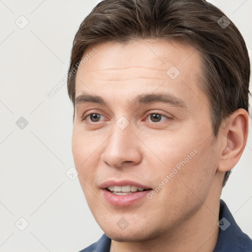 Joyful white young-adult male with short  brown hair and brown eyes