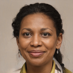 Joyful black adult female with medium  brown hair and brown eyes