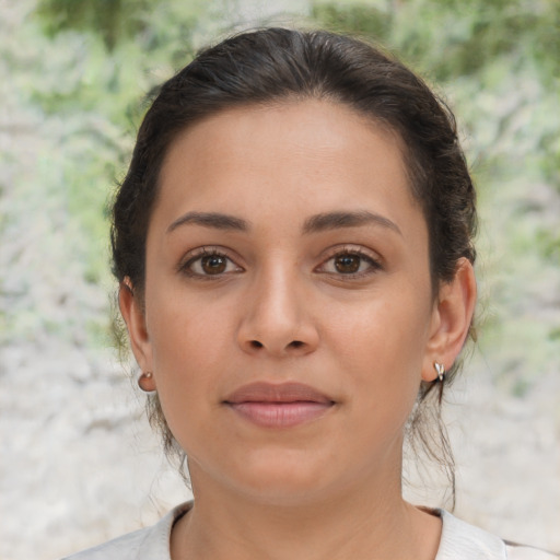 Joyful latino young-adult female with short  brown hair and brown eyes