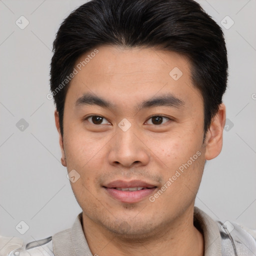 Joyful asian young-adult male with short  brown hair and brown eyes