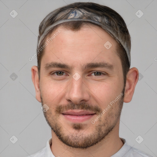 Joyful white young-adult male with short  brown hair and brown eyes