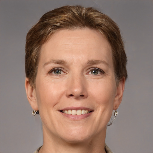 Joyful white adult female with medium  brown hair and grey eyes