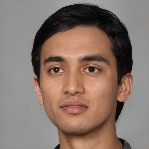 Neutral latino young-adult male with short  black hair and brown eyes