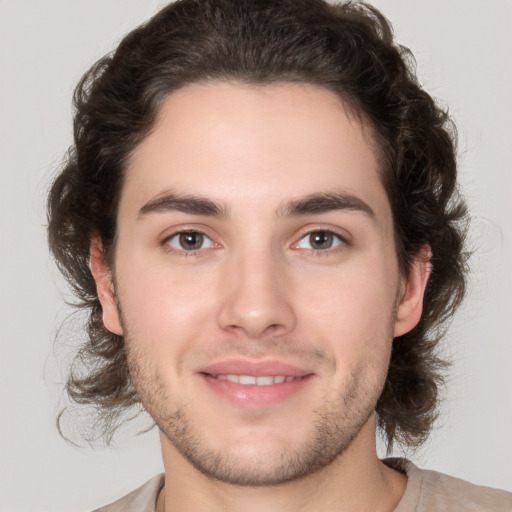 Joyful white young-adult male with medium  brown hair and brown eyes