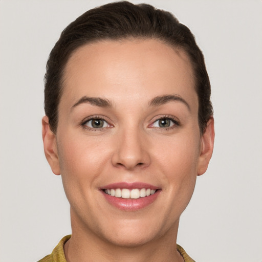 Joyful white young-adult female with short  brown hair and brown eyes