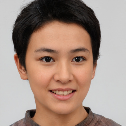 Joyful asian young-adult female with short  brown hair and brown eyes