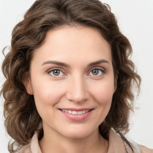 Joyful white young-adult female with medium  brown hair and green eyes