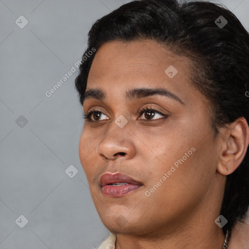 Joyful black young-adult female with short  black hair and brown eyes