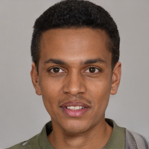 Joyful black young-adult male with short  black hair and brown eyes