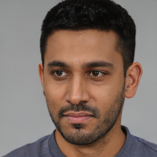 Neutral latino young-adult male with short  black hair and brown eyes