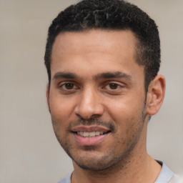 Joyful white young-adult male with short  black hair and brown eyes