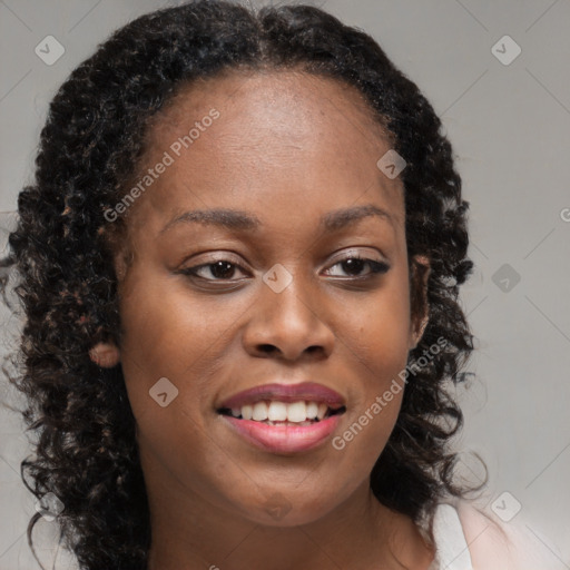 Joyful black young-adult female with long  brown hair and brown eyes