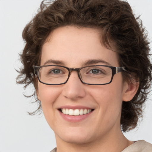 Joyful white young-adult female with medium  brown hair and green eyes