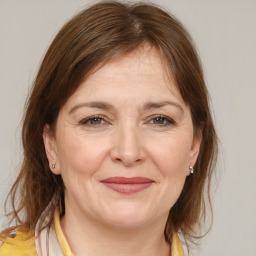 Joyful white adult female with medium  brown hair and brown eyes