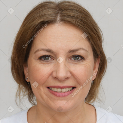 Joyful white adult female with medium  brown hair and brown eyes