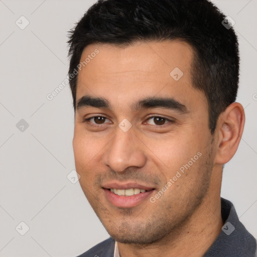 Joyful white young-adult male with short  black hair and brown eyes