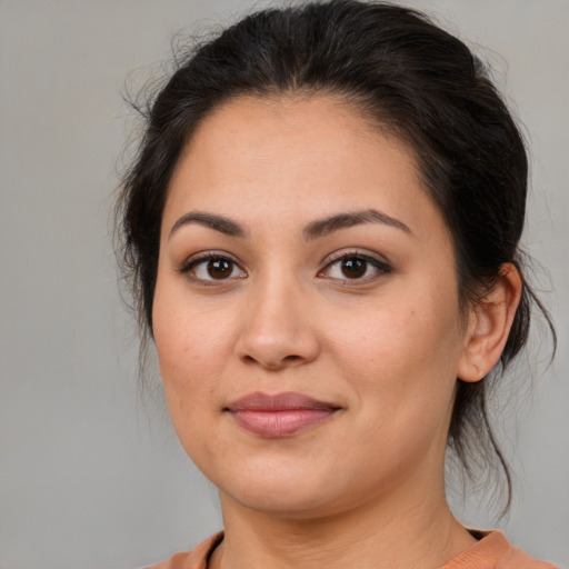 Joyful latino young-adult female with medium  brown hair and brown eyes