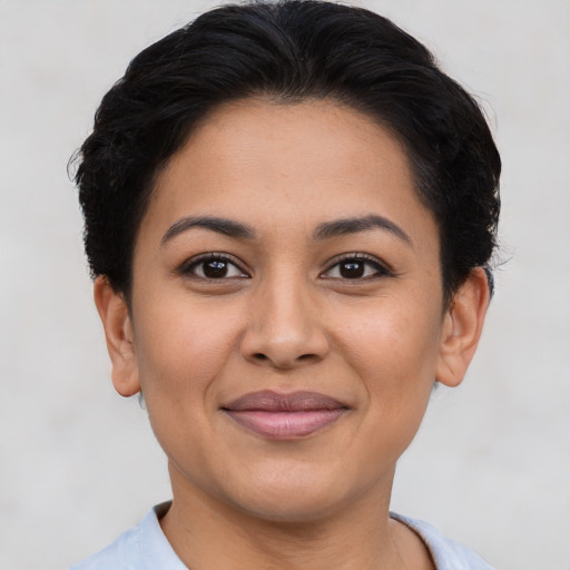 Joyful latino young-adult female with short  brown hair and brown eyes