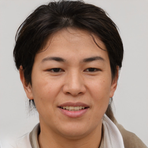 Joyful asian adult female with medium  brown hair and brown eyes