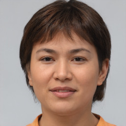 Joyful asian young-adult female with short  brown hair and brown eyes