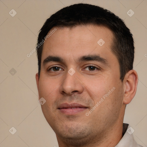 Joyful white young-adult male with short  black hair and brown eyes