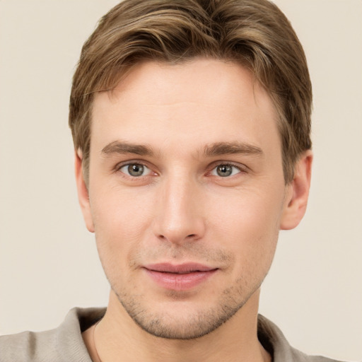 Joyful white young-adult male with short  brown hair and grey eyes