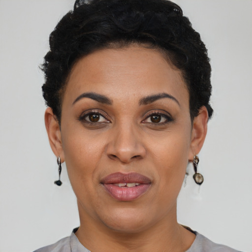 Joyful black young-adult female with short  black hair and brown eyes