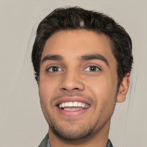 Joyful white young-adult male with short  black hair and brown eyes