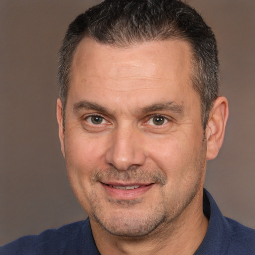 Joyful white adult male with short  brown hair and brown eyes