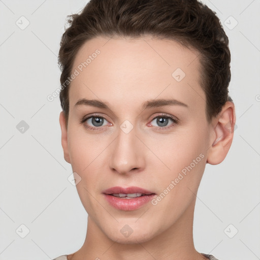 Joyful white young-adult female with short  brown hair and grey eyes