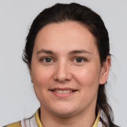 Joyful white young-adult female with medium  brown hair and brown eyes