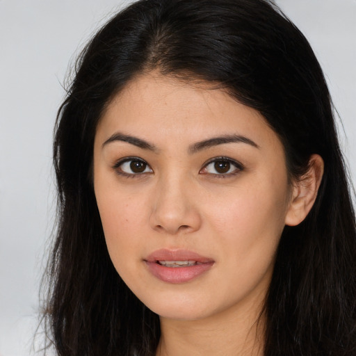 Joyful asian young-adult female with long  brown hair and brown eyes