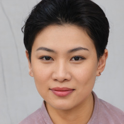 Joyful asian young-adult female with short  brown hair and brown eyes