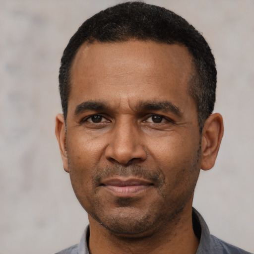 Joyful latino adult male with short  black hair and brown eyes