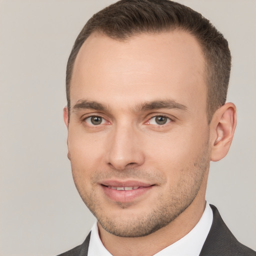 Joyful white young-adult male with short  brown hair and brown eyes