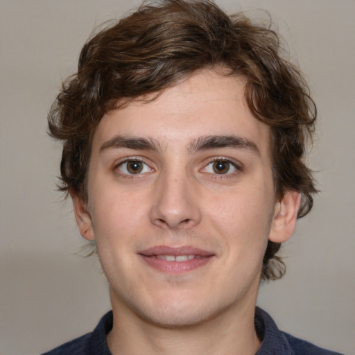 Joyful white young-adult male with medium  brown hair and brown eyes