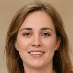 Joyful white young-adult female with long  brown hair and green eyes