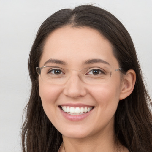 Joyful white young-adult female with long  brown hair and grey eyes