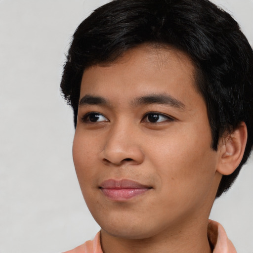 Joyful asian young-adult male with short  brown hair and brown eyes