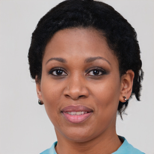 Joyful black adult female with short  black hair and brown eyes
