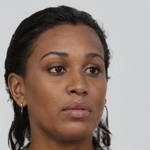 Neutral black young-adult female with medium  brown hair and brown eyes