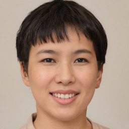 Joyful asian young-adult female with short  brown hair and brown eyes