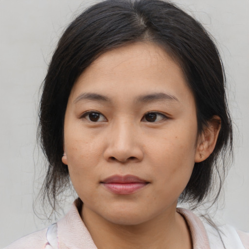 Joyful asian young-adult female with medium  brown hair and brown eyes