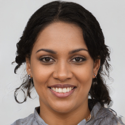 Joyful black young-adult female with medium  brown hair and brown eyes